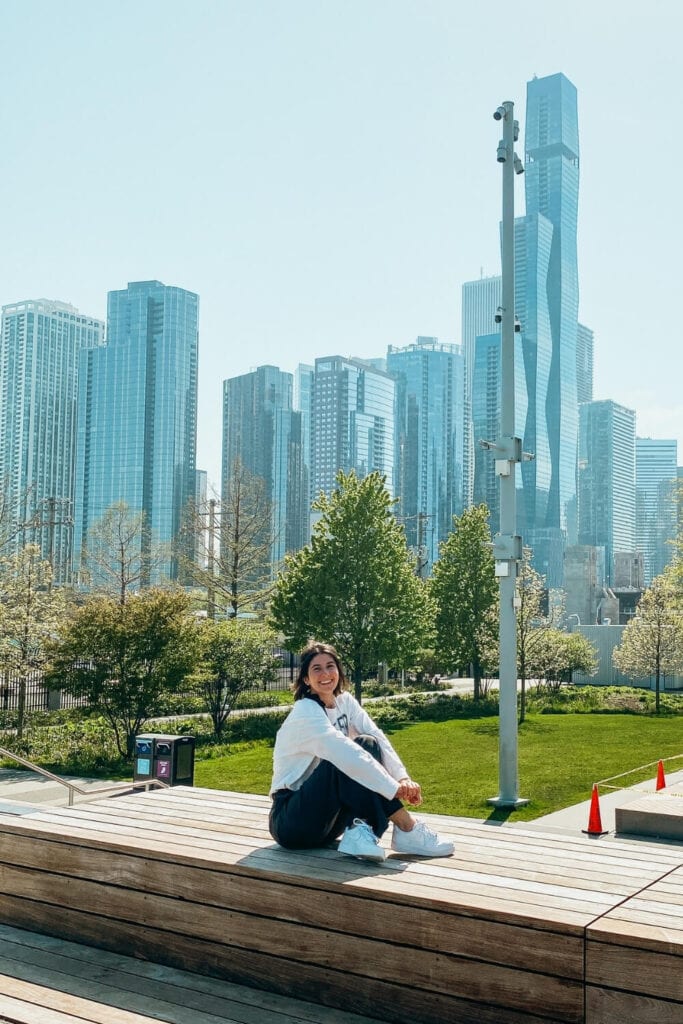 girl sitting on on steps outside of navy pier chicago