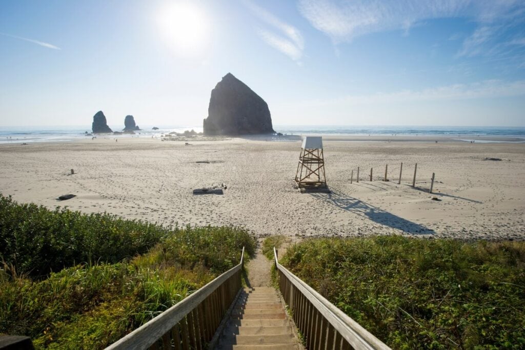 sunny day on the walkway heading down to haystack rock cannon beach oregon