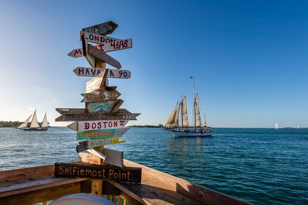 sign point in different directions in key west florida over the ocean