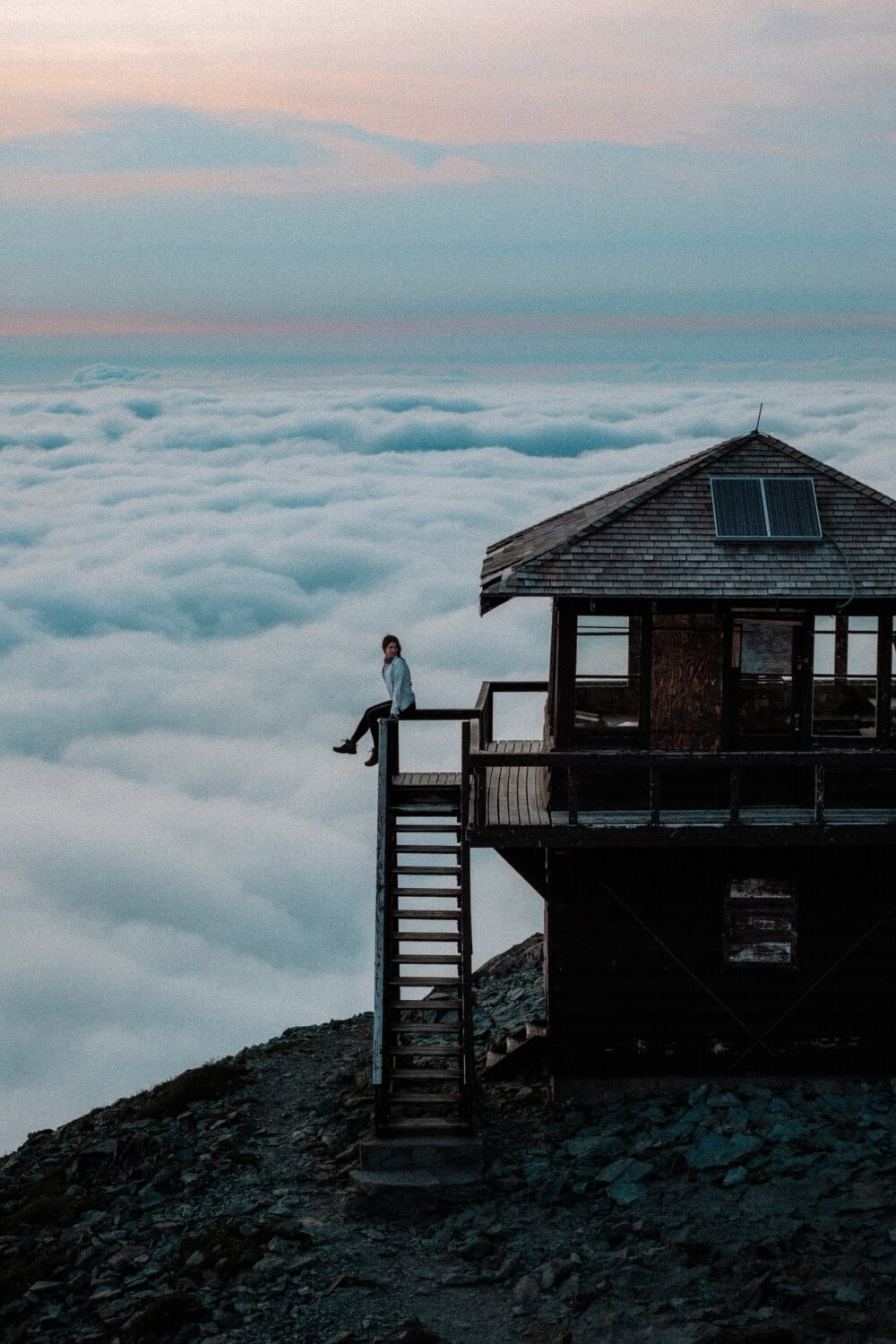 female hiker sitting at the fire lookout on Mt. Fremont Fire Lookout trail