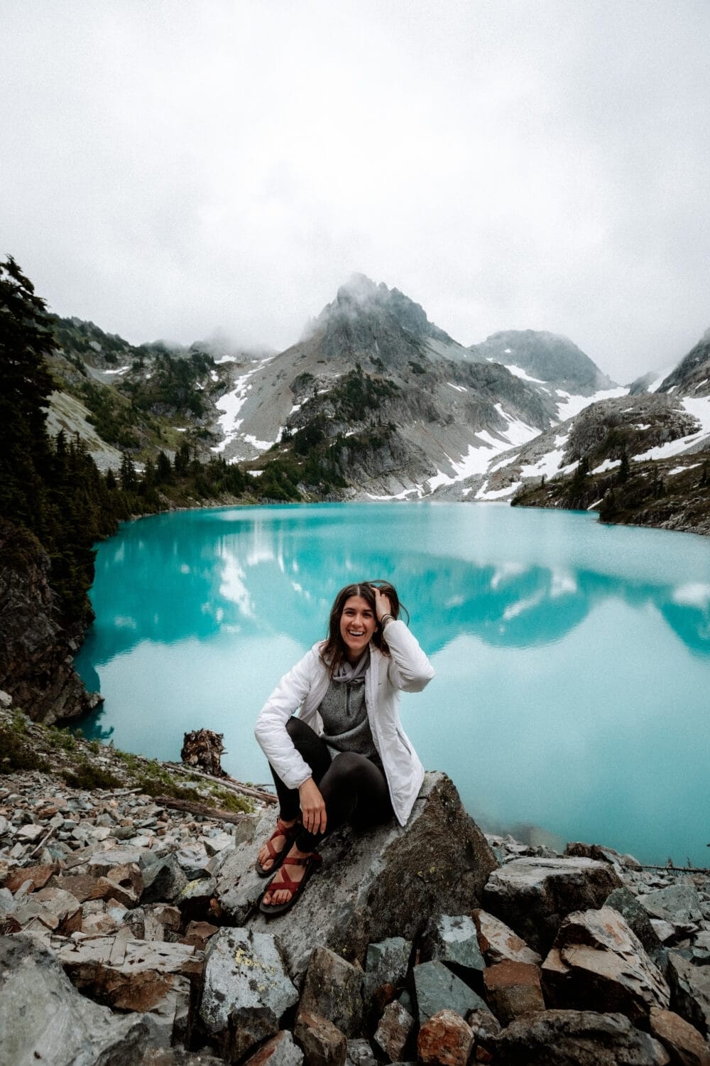 female hiker sitting near jade lake washington