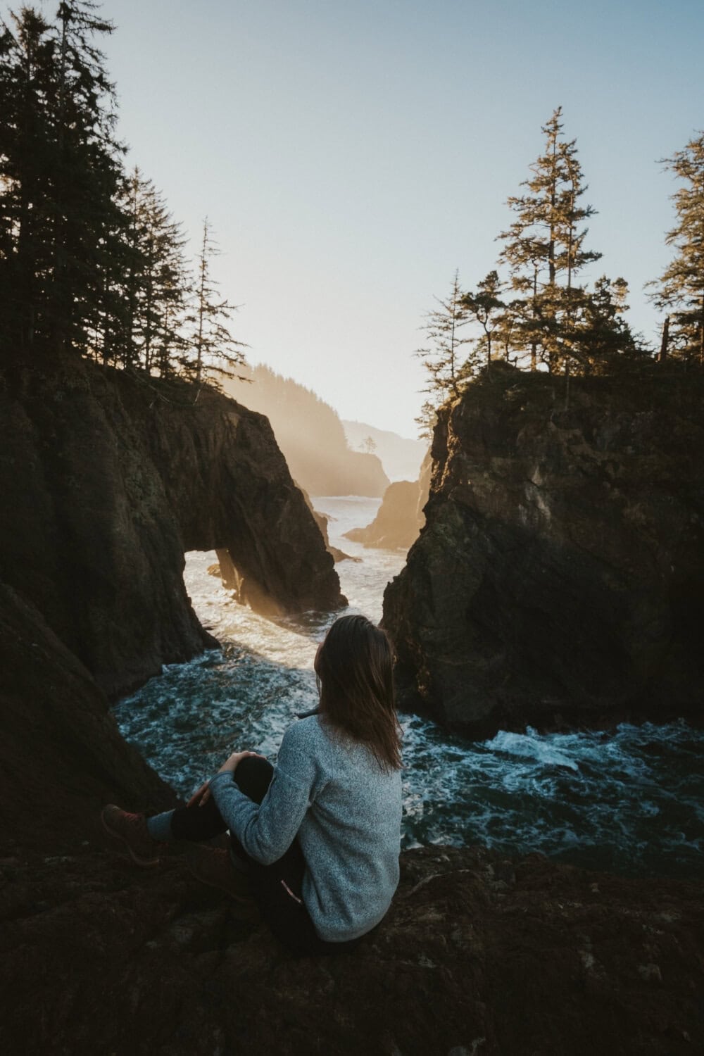 girl watching sunrise over natural bridges Samuel H. Boardman State Scenic Corridor