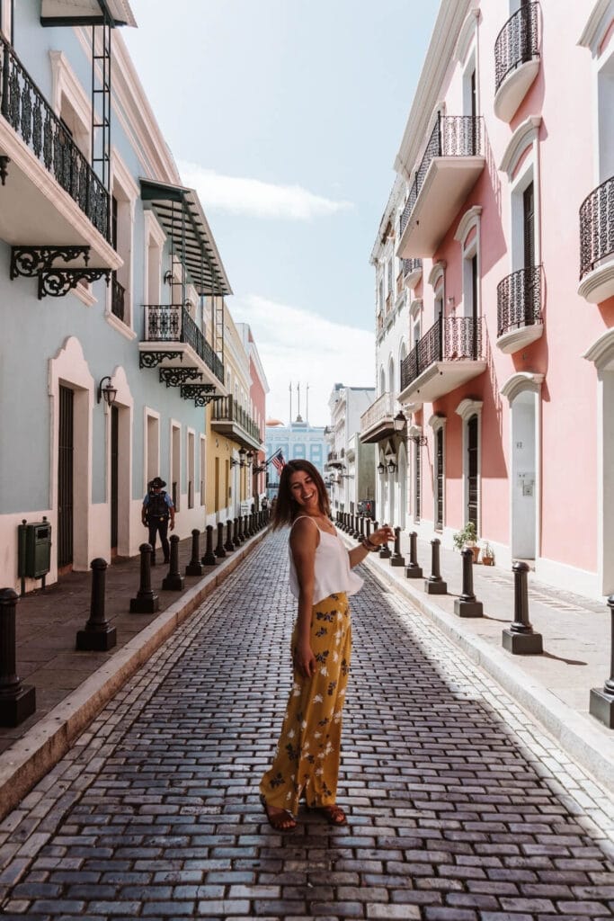 female traveler in yellow pants visiting Calle Fortaleza in puerto rico