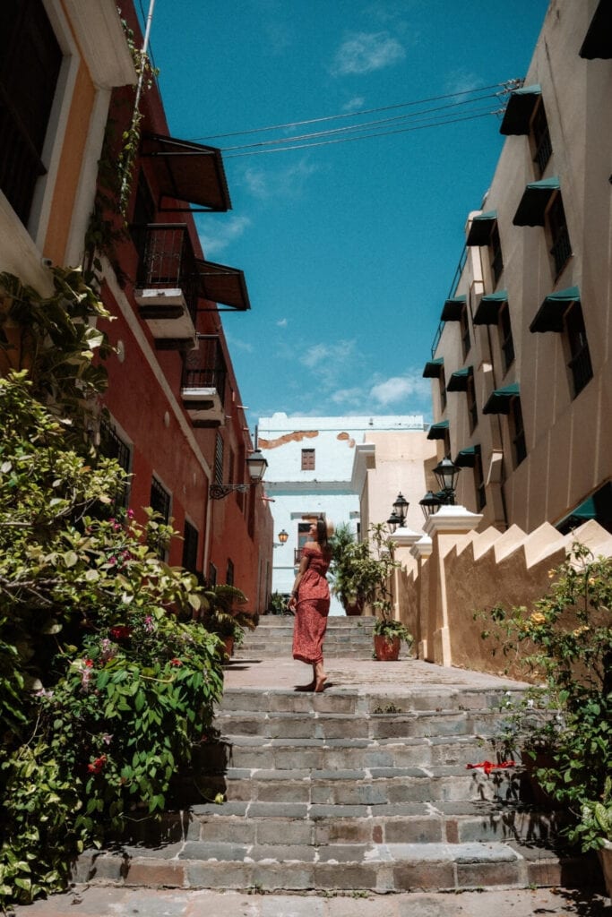 girl in red dress standing outside the steps on hotel el convento