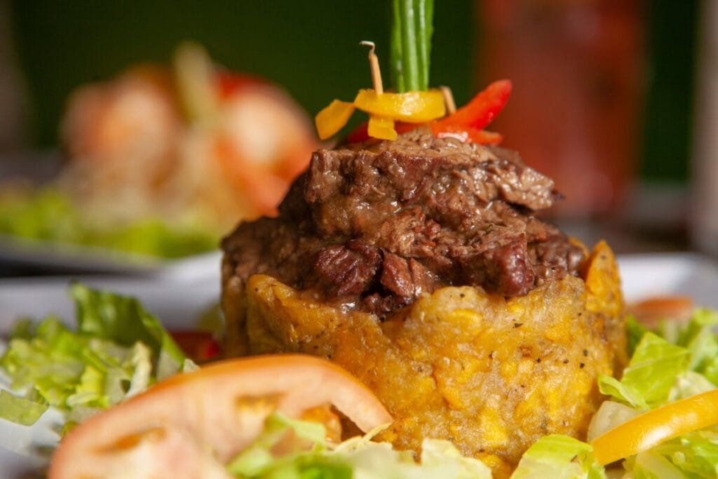 meat on top of traditional mofongo from puerto rico