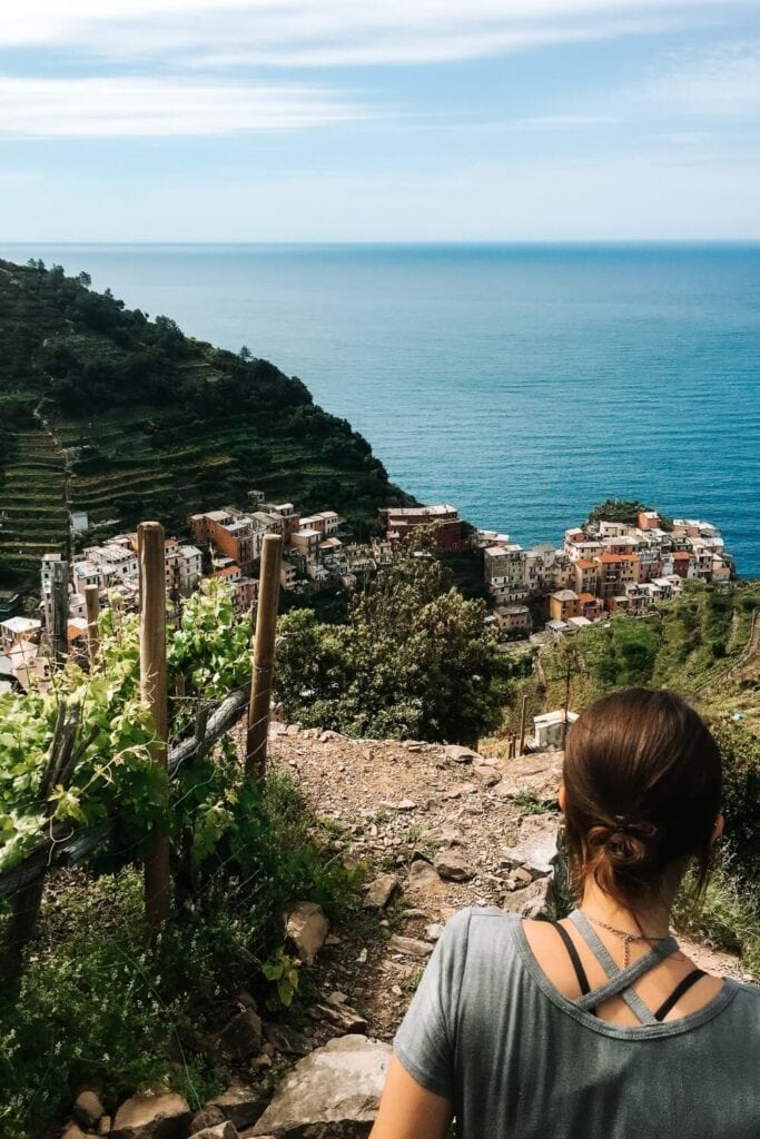 female hiker taking the trail down to Riomaggiore